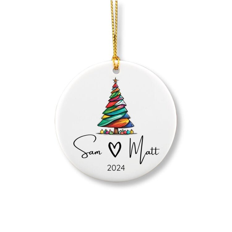 Personalized couple round ornament featuring a colorful Christmas tree with a couple first names and year.