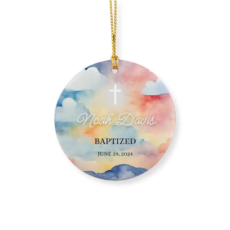 Personalized baptism ornament for little boys featuring a drawing of clouds at sunset and the light of god coming through the cross, a name and the baptism date