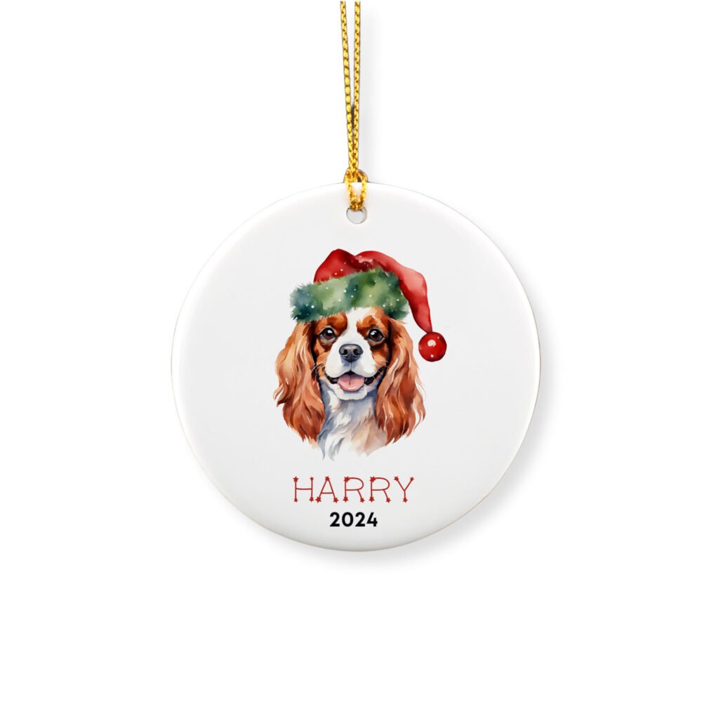 Personalized ornament showcasing a cavalier king charles spaniel dog with a red hat and a name