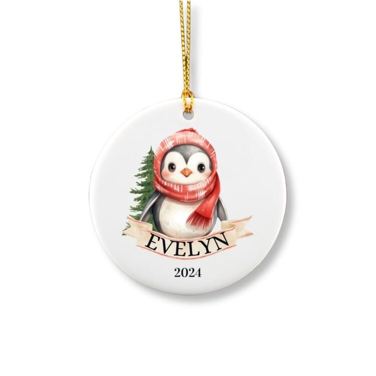 Personalized Penguin ornament with name in front of a tree